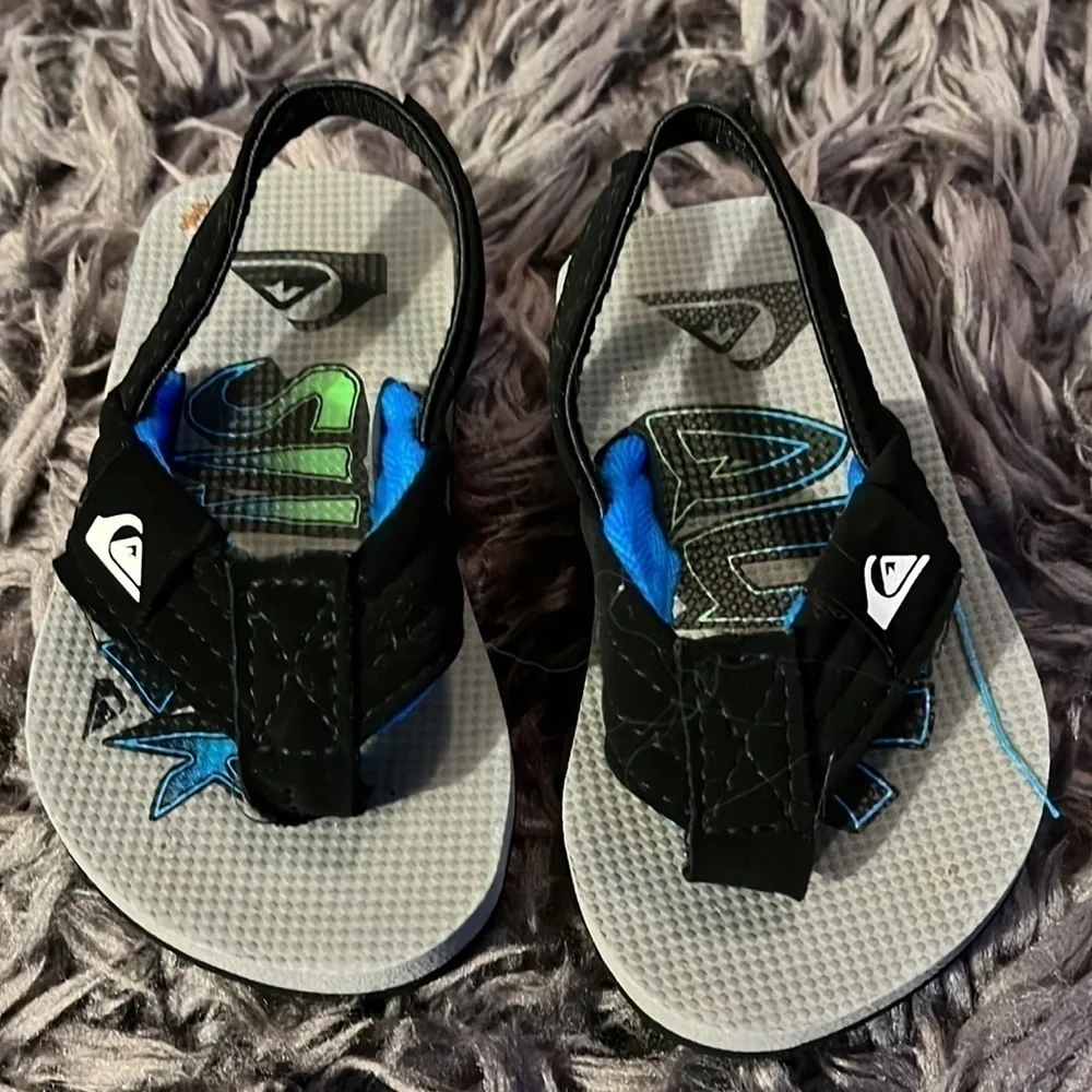 Quicksilver black and blue flip flops for boys.